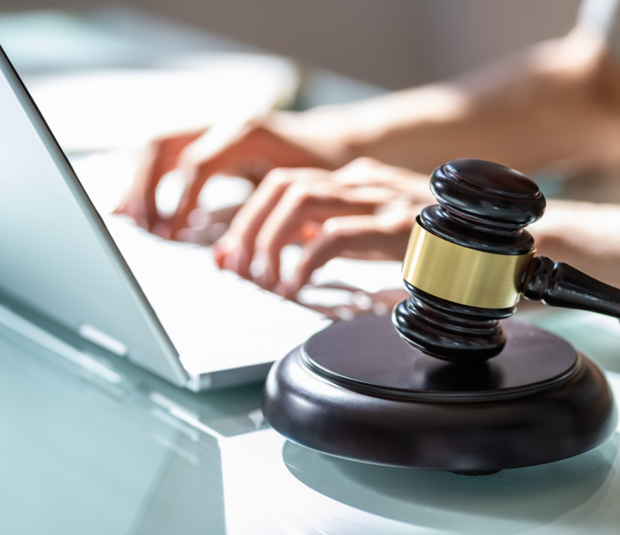 Person sitting at laptop with gavel