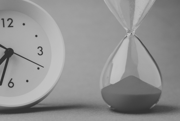 Picture of a clock next to a sand timer