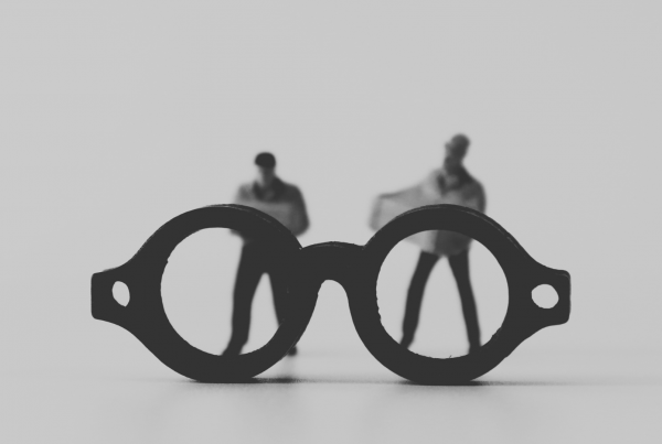 A pair of glasses looking at to different people