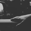 Driving car with arm resting on door