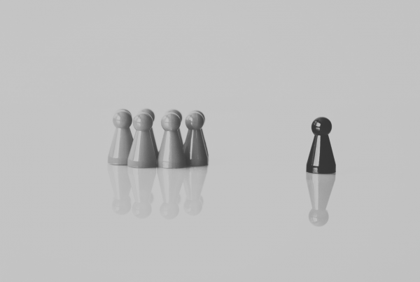 Six pawn pieces in a group with one single piece left out