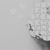 Head jigsaw puzzle being held by multiple hands