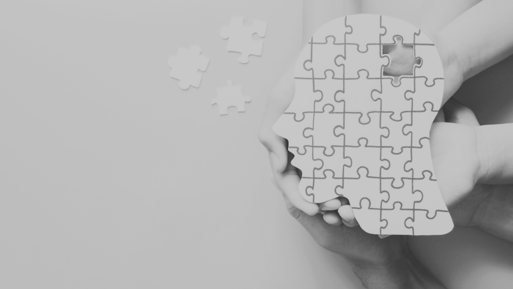 Head jigsaw puzzle being held by multiple hands