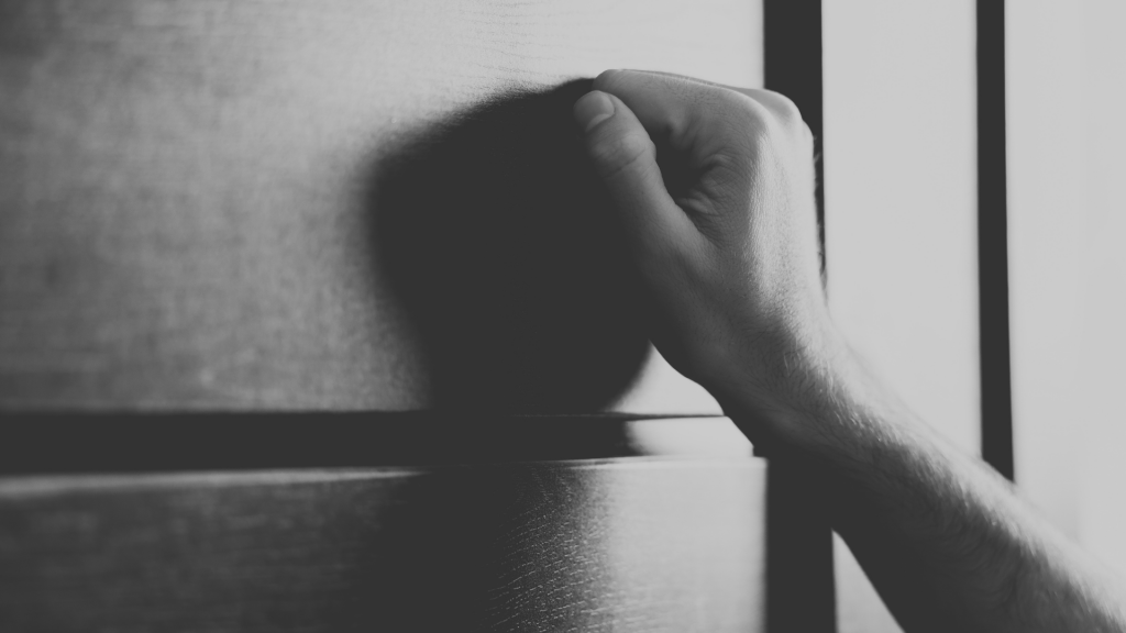 Hand knocking on door