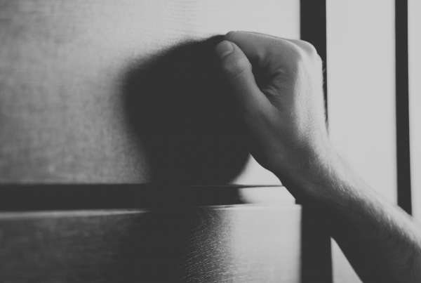 Hand knocking on door