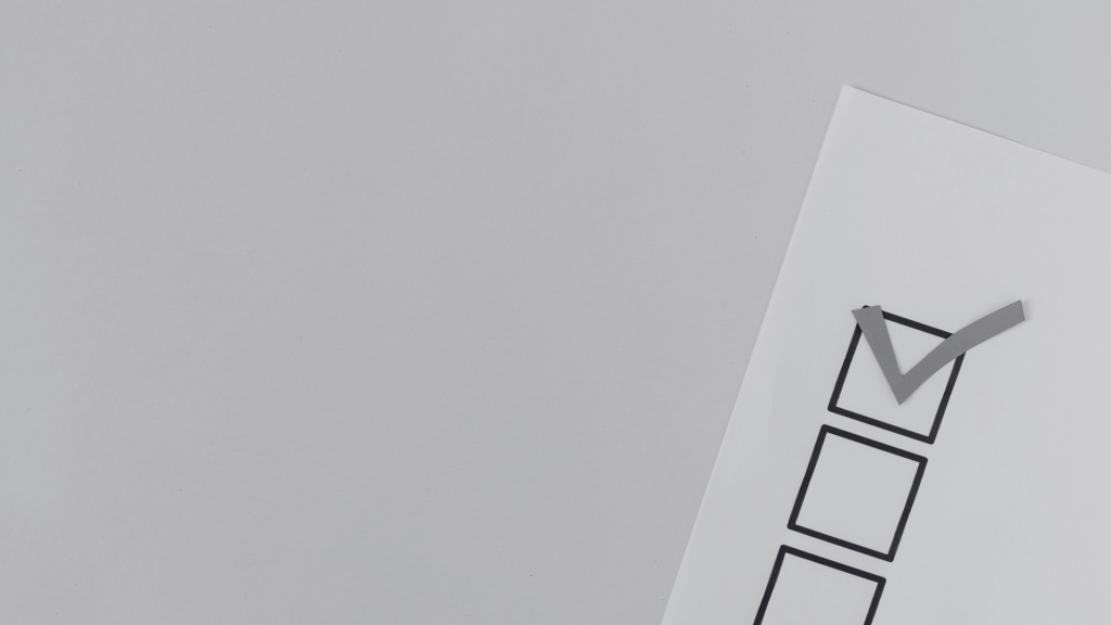 White paper with three boxes and a tick in one box