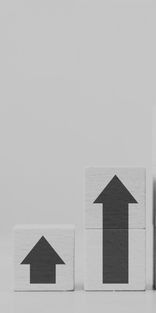 Wooden blocks with arrows pointing up - stacked